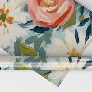 May include: Floral wrapping paper with a blue background and white, pink, and orange flowers. The paper is rolled up and the end of the roll is visible.
