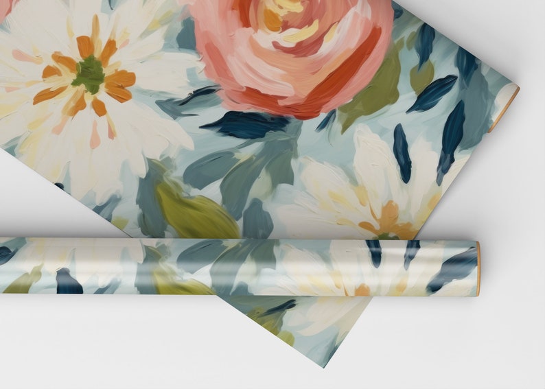 May include: Floral wrapping paper with a blue background and white, pink, and orange flowers. The paper is rolled up and the end of the roll is visible.