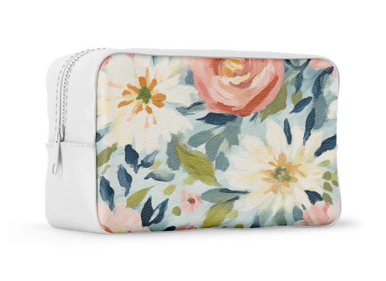 May include: White zippered pouch with a floral print featuring pink, white, and blue flowers on a light blue background.