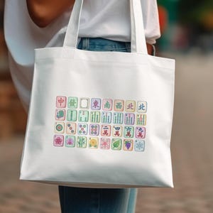 White tote bag with colorful Mahjong tiles and Chinese characters.