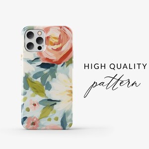 May include: A phone case with a floral pattern. The case features a light blue background with pink, white, and red flowers. The case has a camera cutout for a triple lens camera.