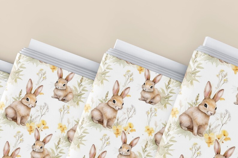 May include: A set of three white gift bags with a repeating pattern of brown bunnies and yellow flowers. The bags are stacked on top of each other.
