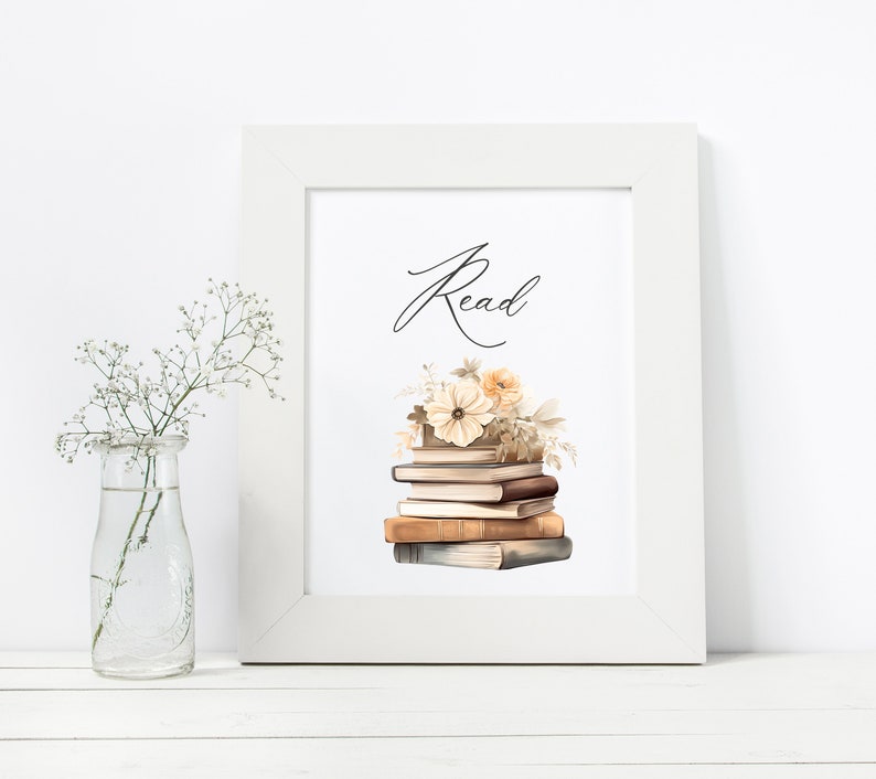 May include: A white framed print with the word "Read" in cursive script. A stack of vintage books with a floral arrangement on top is pictured below the word.