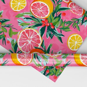May include: Pink wrapping paper with a repeating pattern of lemons and grapefruits, green leaves, and red berries.