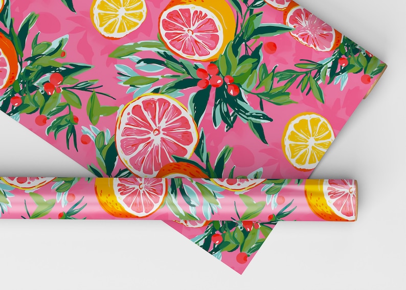 May include: Pink wrapping paper with a repeating pattern of lemons and grapefruits, green leaves, and red berries.