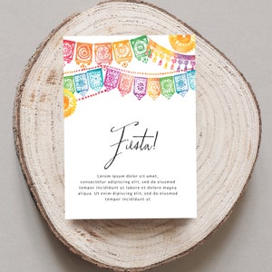 May include: A white card with the word "Fiesta!" written in black cursive script. The card is decorated with a colourful string of paper flags with a watercolour effect. The text below the word "Fiesta!" reads "Lorem ipsum dolor sit amet, consectetur adipiscing elit, sed do eiusmod tempor incididunt ut labore et dolore magna aliqua. Ut enim dipiscing elit, sed do eiusmod tempor incididunt ut"