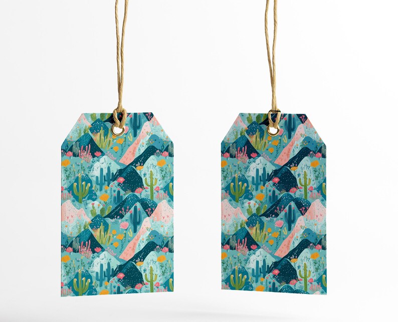 May include: Two turquoise blue gift tags with a repeating pattern of pink and blue mountains, green cacti, and yellow flowers. The tags are hanging from twine.