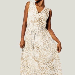 May include: A white sleeveless maxi dress with a delicate lace pattern. The dress has a V-neckline and a tie at the waist.