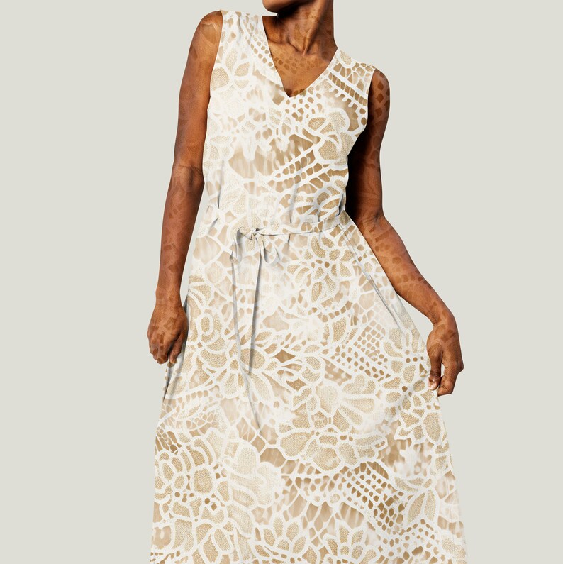 May include: A white sleeveless maxi dress with a delicate lace pattern. The dress has a V-neckline and a tie at the waist.