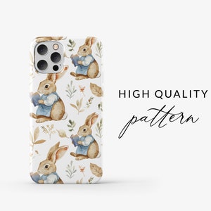 May include: A white phone case with a repeating pattern of brown rabbits holding books, blue dresses, and brown leaves. The text "HIGH QUALITY pattern" is visible on the right side of the image.