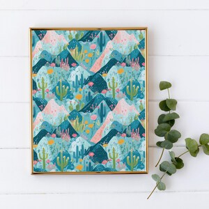 May include: A framed print with a repeating pattern of blue, pink, and green mountains with cacti and flowers. The frame is gold.