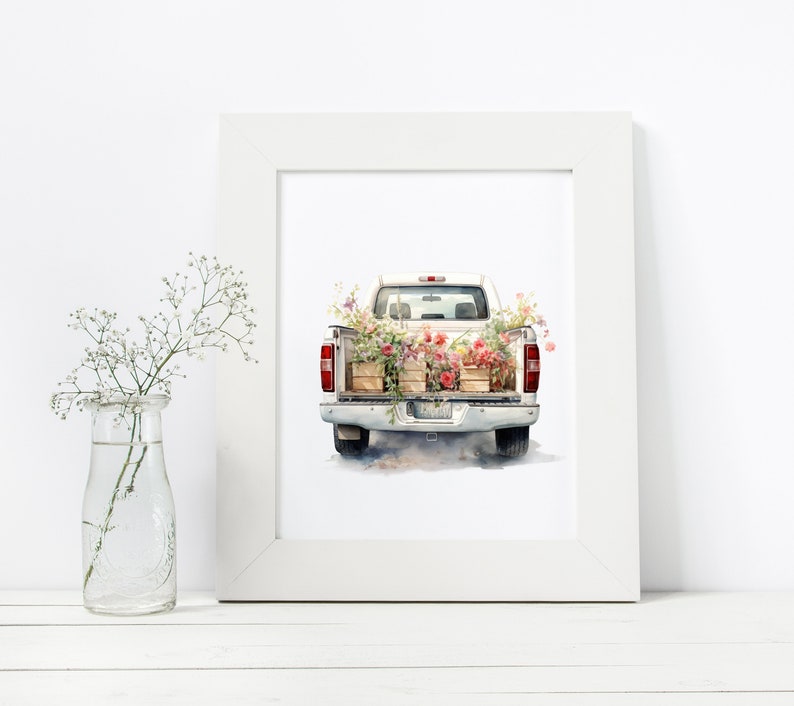 May include: A white pickup truck with the tailgate down, filled with wooden crates of pink and red flowers. The truck is on a white background.