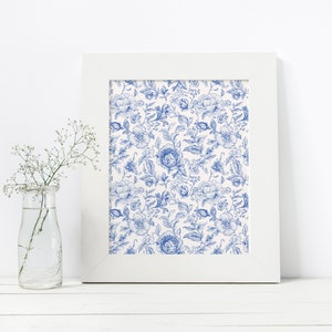 May include: A white frame with a blue and white floral print inside. The print features a repeating pattern of blue flowers and leaves on a white background.