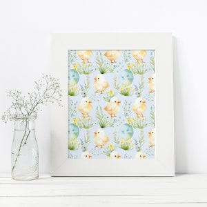 May include: A white frame with a blue background and a repeating pattern of yellow chicks, green leaves, and blue eggs. The chicks are facing different directions and have yellow beaks and feet.