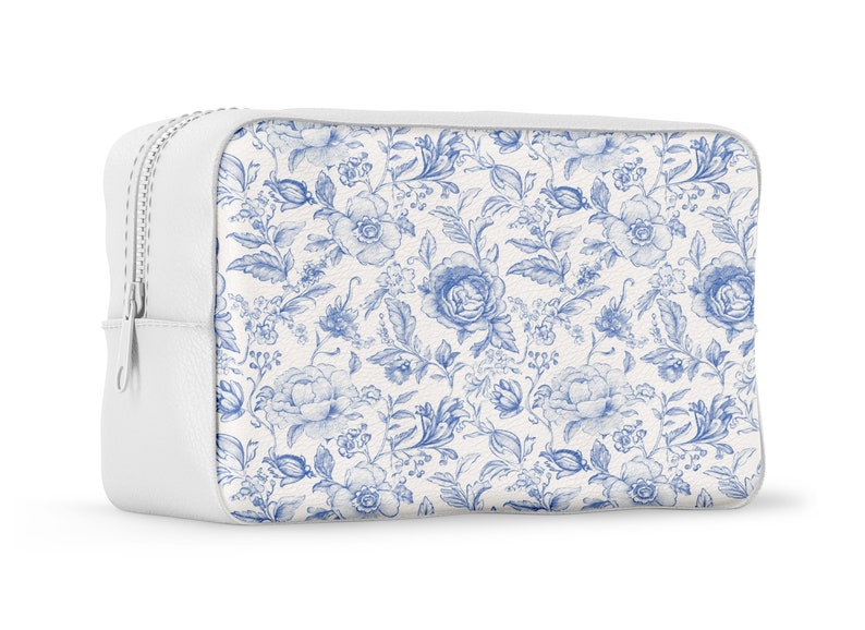 May include: White zippered pouch with a blue and white floral pattern. The pouch is made of a soft, textured material.