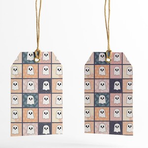 May include: Two gift tags featuring a repeating pattern of white cartoon ghosts on a patchwork background of pink, peach, blue, and navy squares. Each tag is rectangular with a rounded top and a hole for a natural twine string.