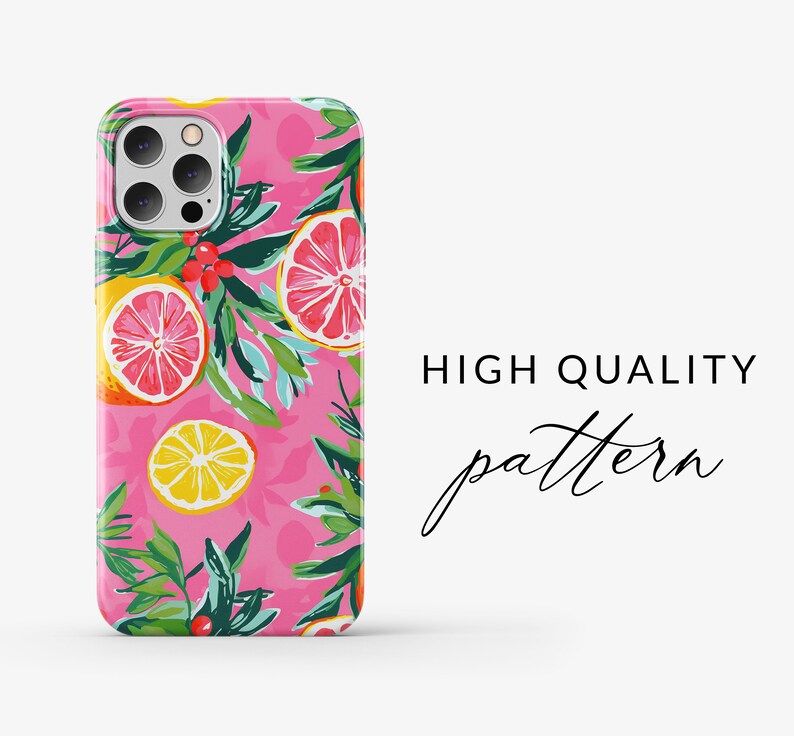 May include: A pink phone case with a colorful pattern of lemons, grapefruits, and green leaves. The case has a cutout for the camera lens.