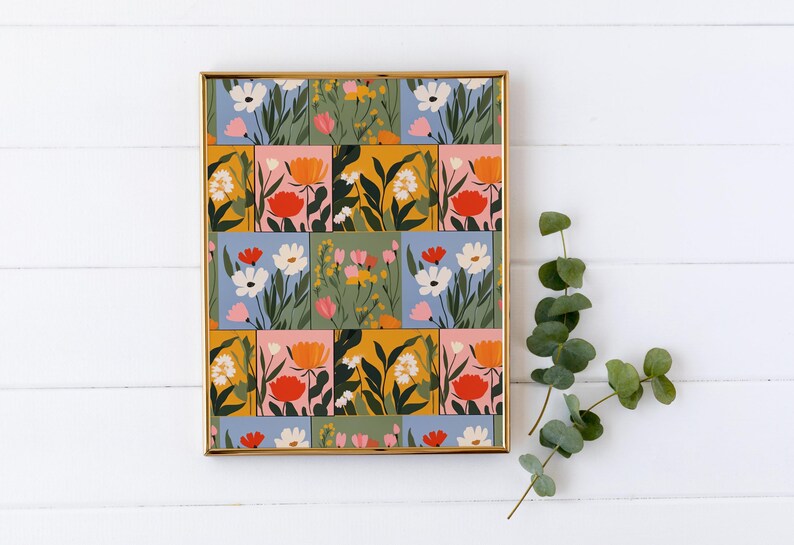 May include: A framed print featuring a colourful floral pattern. The print has a patchwork design of squares with different coloured backgrounds and floral illustrations in shades of pink, orange, yellow, blue, and green.