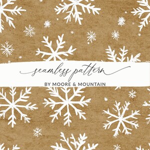 May include: A seamless pattern featuring white snowflakes on a brown background. The text "seamless pattern" and "BY MOORE & MOUNTAIN" is printed in white on a white banner.