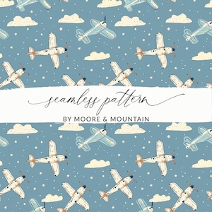 May include: A seamless pattern with illustrations of vintage aeroplanes, clouds, and stars on a blue backdrop. The aeroplanes are white and light blue with brown propellers. The text "seamless pattern" and "BY MOORE & MOUNTAIN" are displayed on a white banner.