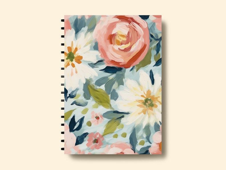 May include: A spiral bound notebook with a floral design. The cover features a colourful pattern of pink, white and blue flowers with green leaves.