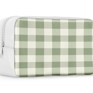 May include: White zippered pouch with a green and white gingham pattern.