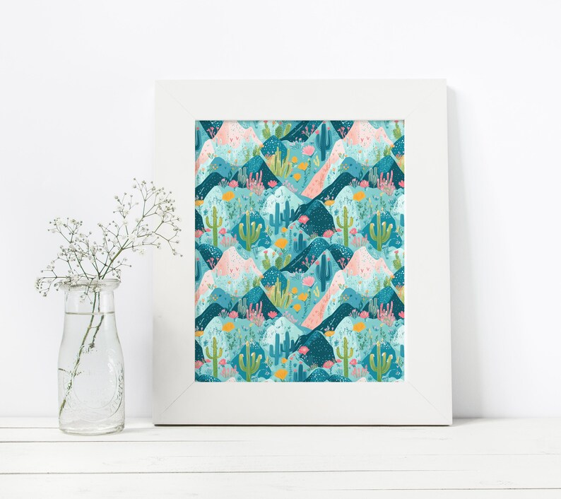 May include: A framed print with a repeating pattern of blue, pink, and green mountains, cacti, and flowers. The print has a white frame.