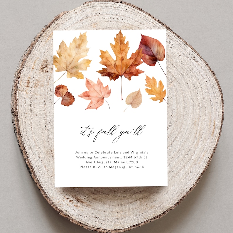 May include: Autumn wedding announcement featuring a watercolour illustration of autumn leaves in shades of orange, red, and yellow. The text reads "It's fall ya'll" and includes the couple's names, wedding date, and RSVP details.