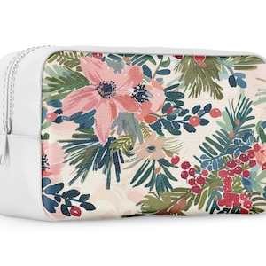 May include: White zippered pouch with a floral print featuring pink flowers, green leaves, and red berries.