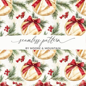 May include: A seamless pattern featuring watercolor illustrations of Christmas-themed bread loaves with red bows, green pine branches, and red berries. The text "seamless pattern" and "BY MOORE & MOUNTAIN" is included in the design.