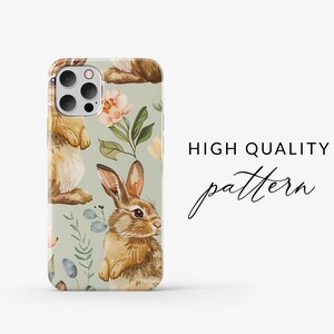 May include: A phone case with a green background and a repeating pattern of brown rabbits and pink flowers. The text "HIGH QUALITY pattern" is visible in the background.