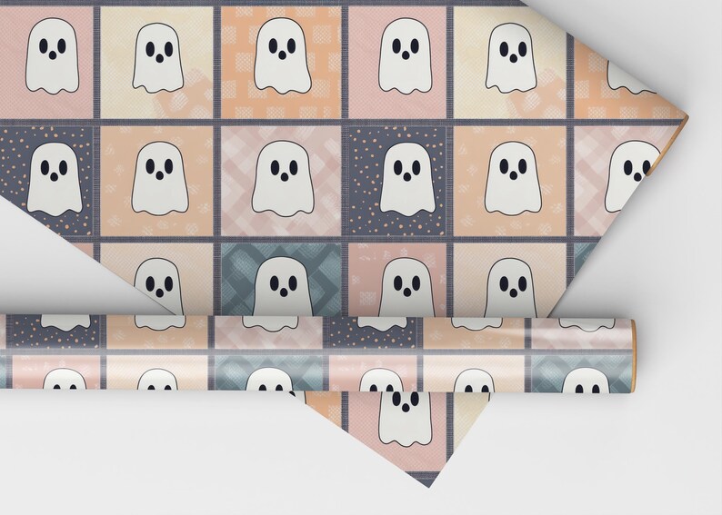 May include: A roll of patterned paper with a repeating design of white ghost figures on a patchwork background of pastel squares. The squares are in shades of pink, peach, and blue, with a hint of a grid pattern.