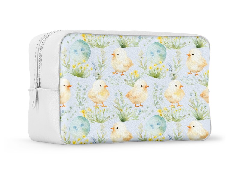 May include: White zippered cosmetic bag with a light blue background and a repeating pattern of yellow chicks and blue eggs with green foliage.