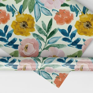 May include: Floral wrapping paper with a white background and a repeating pattern of pink, yellow, and orange flowers with blue leaves.