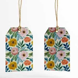 May include: Two floral gift tags with a white background and a watercolor pattern of pink, yellow, and orange flowers with green leaves. The tags are attached to twine.
