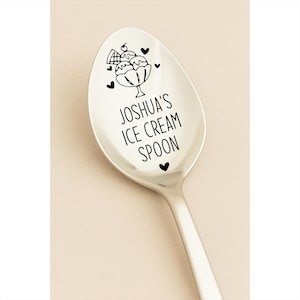 May include: A stainless steel ice cream spoon with a black illustration of an ice cream sundae and hearts. The text "JOSHUA'S ICE CREAM SPOON" is printed on the spoon.