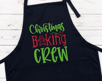 May include: A black apron with a large front pocket and adjustable neck strap. The apron features the text "Christmas Baking CREW" in green and red, with a gingerbread man graphic. The apron is designed for cooking and baking.