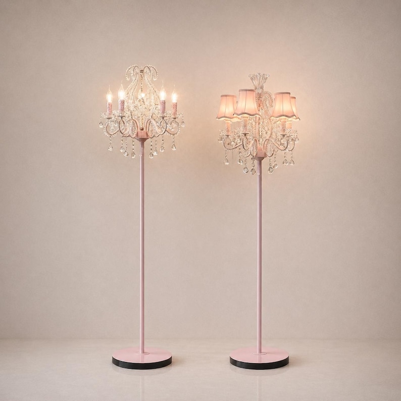 May include: Two pink floor lamps with crystal chandelier-style light fixtures. One lamp has exposed bulbs, while the other has pink lampshades. The lamps have a pink base and stem, and a black, semi-circular base.
