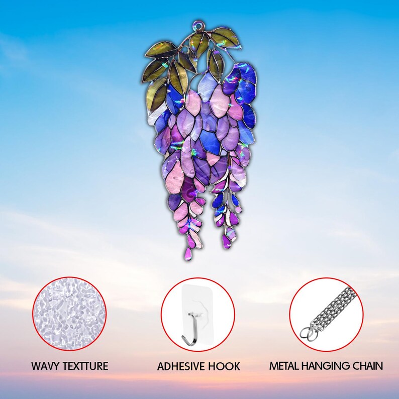 Pu&ograve; includere: Decorazione da appendere in vetro colorato a forma di glicine. Presenta petali viola, blu e rosa e foglie verdi. Include un gancio adesivo e una catena di metallo per appenderla.