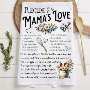 May include: White kitchen towel with a recipe for "Mama's Love" printed on it. The recipe includes ingredients like unconditional love, patience, laughter, and joy. The towel is decorated with daisies and hearts.