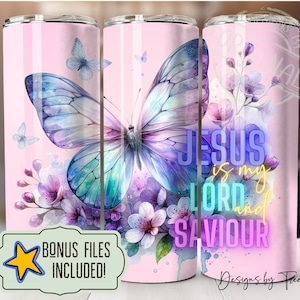 May include: A pink tumbler with a watercolor butterfly design and the text "JESUS is my LORD and SAVIOUR" in neon colors. The butterfly has purple, blue, and green wings. The background is pink with watercolor flowers.
