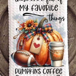 May include: A decorative kitchen towel featuring a watercolor design with a large orange pumpkin, a football, and a coffee cup. The towel has the text "These are a few of my favorite things" and "Pumpkins Coffee & Football."