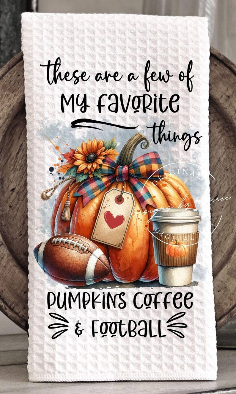 May include: A decorative kitchen towel featuring a watercolor design with a large orange pumpkin, a football, and a coffee cup. The towel has the text "These are a few of my favorite things" and "Pumpkins Coffee & Football."