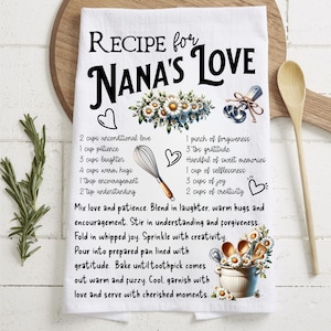 May include: A white kitchen tea towel with a black and white recipe for "Nana's Love" printed on it. The recipe includes ingredients such as unconditional love, patience, laughter, warm hugs, encouragement, understanding, forgiveness, gratitude, sweet memories, selflessness, joy, and creativity. The towel is decorated with floral illustrations and kitchen utensils.