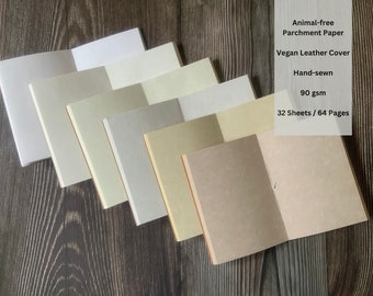 May include: A stack of six blank, hand-sewn notebooks with vegan leather covers. The notebooks are made with animal-free parchment paper and have 32 sheets (64 pages) each. The paper is 90 gsm.
