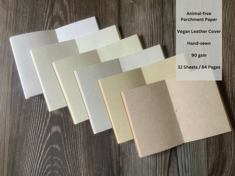 6 travelers notebook inserts open at the middle and stacked in an offset matter on top of each other.  Each notebook showcases the different available page colors including white, fleece white, natural, storm, aged, and camel.