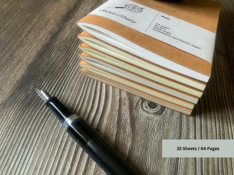 A stack of 6 travelers notebook inserts.  The picture is angled so that the edges of the papers are shown.  The differences in the 6 available page colors are apparent here, including white, fleece white, natural, storm, aged, and camel.