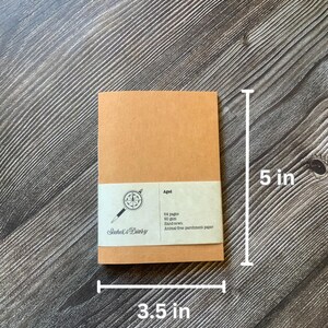 One passport size travelers notebook insert.  The covers are made of a brown vegan leather, also known as washable paper.  It has a smooth texture on one side and a rougher texture on the other side.  The height is 5 in. and the width is 3.5 in.