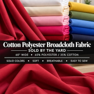 Könnte beinhalten: Ein Stapel gefalteter Baumwoll-Polyester-Popeline-Stoff in verschiedenen Unifarben, darunter Rot, Weiß, Creme, Rosa, Magenta, Gelb, Olivgrün und Blautöne. Der Text lautet: Cotton Polyester Broadcloth Fabric, 152,4 cm breit.