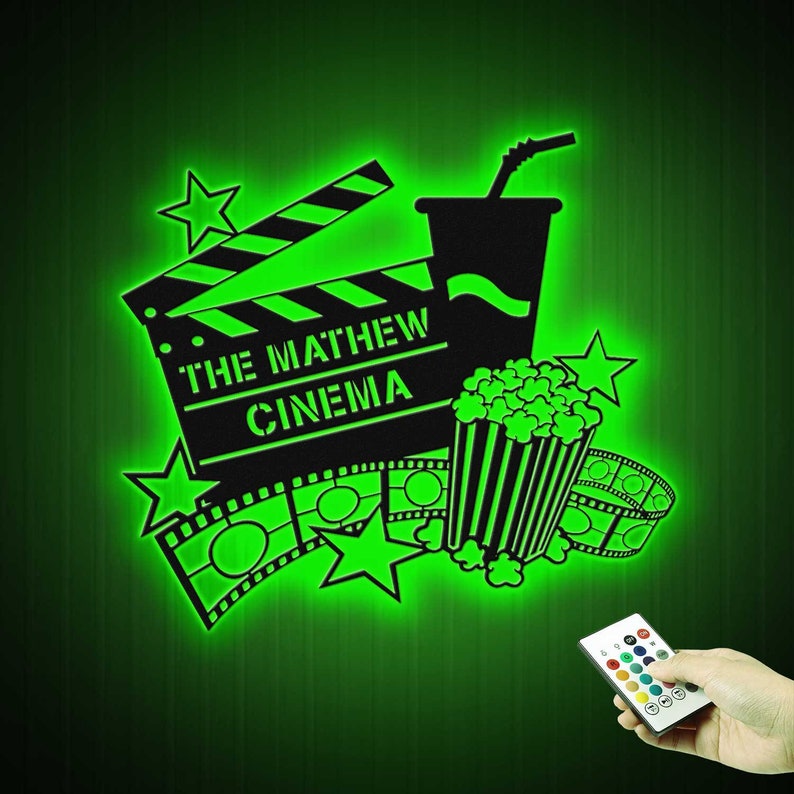 May include: Green glow-in-the-dark wall decal featuring a movie clapperboard, popcorn bucket, and film reel. The clapperboard reads "The Mathew Cinema".